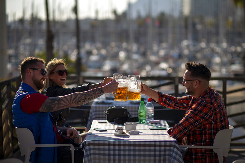 Turistas brindan en un bar reabierto en Barcelona, España, 23 de noviembre de 2020. (AP)