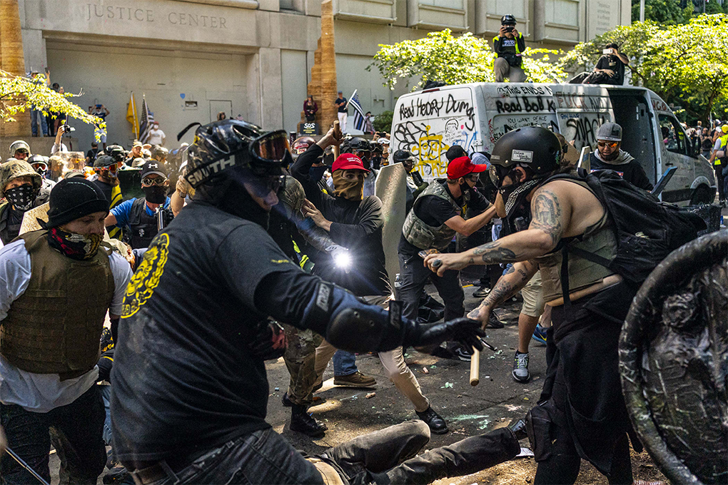 FILE -- A far-right demonstrator uses pepper spray amid clashes with counter-protesters outside the Multnomah County Justice Center in Portland, Ore., on Aug. 22, 2020. Federal law enforcement shifted resources last year in response to Donald Trump’s insistence that the radical left endangered the country. Meanwhile, right-wing extremism was building ominously. (David Ryder/The New York Times)