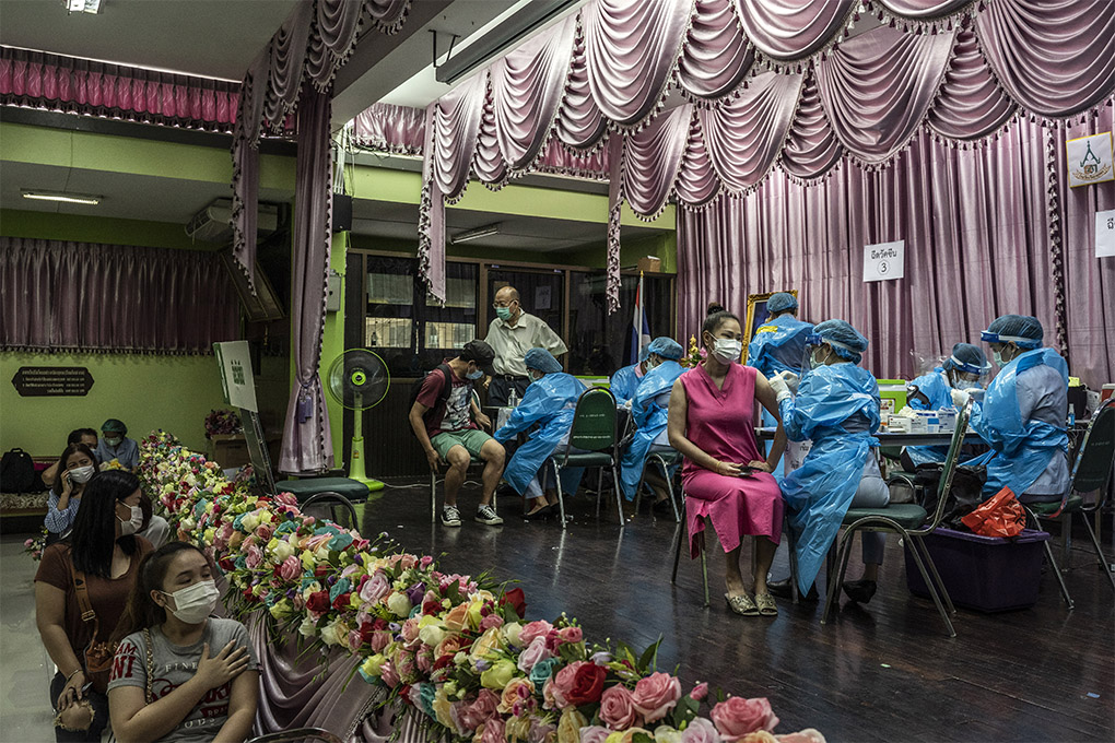 A COVID-19 vaccination center in Bangkok on April 28, 2021. Big-power muscle flexing helps explain much of the world’s vaccine inequities, but there's another reason behind insufficient doses: The challenge of making them is unprecedented. (Adam Dean/The New York Times)
