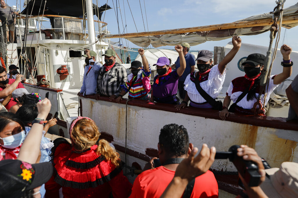 Una delegación del Ejército Zapatista de Liberación Nacional se despide desde un buque el domingo 2 de mayo de 2021 a su partida rumbo a Europa desde Isla Mujeres, estado de Quintana Roo, México. (AP Foto/Eduardo Verdugo)