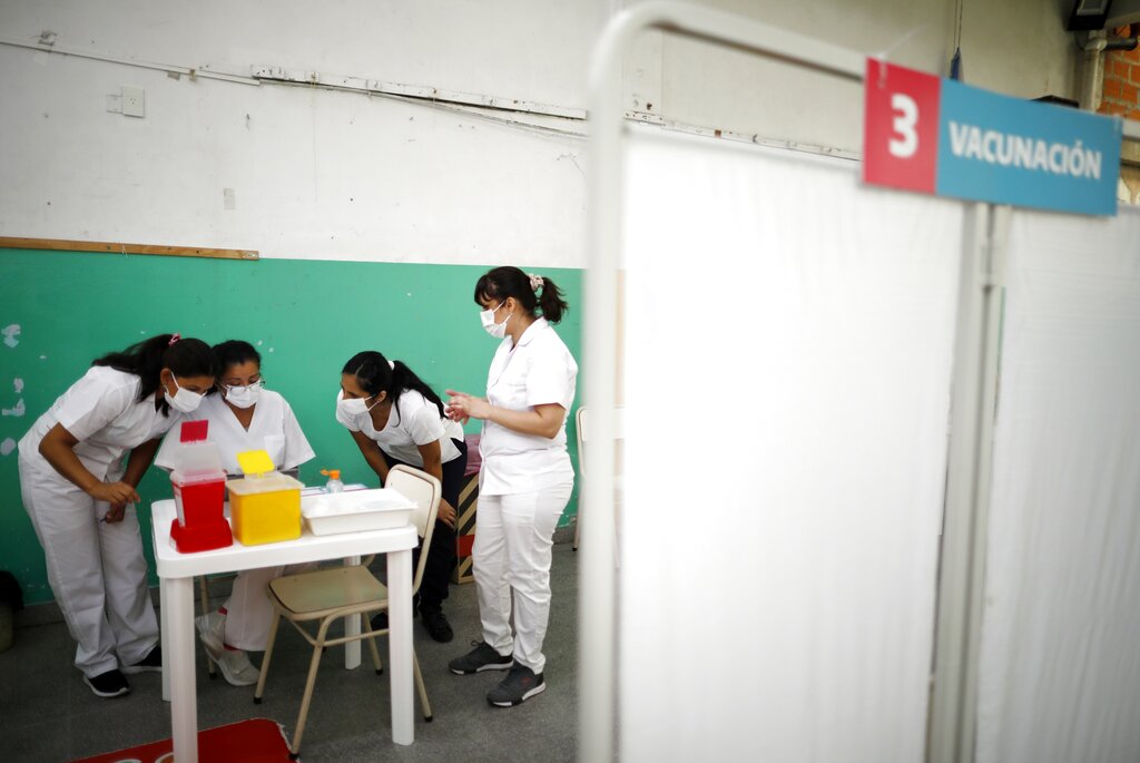 ARCHIVO - En esta foto de archivo del 18 de febrero de 2021, enfermeras leen instrucciones sobre cómo administrar la vacuna Sputnik V contra COVID-19 en una escuela pública de Bernal, en las afueras de Buenos Aires, Argentina. El país sudamericano iniciará en la segunda semana de junio de 2021 la producción local de la vacuna Sputnik V. (AP Foto/Natacha Pisarenko, Archivo)