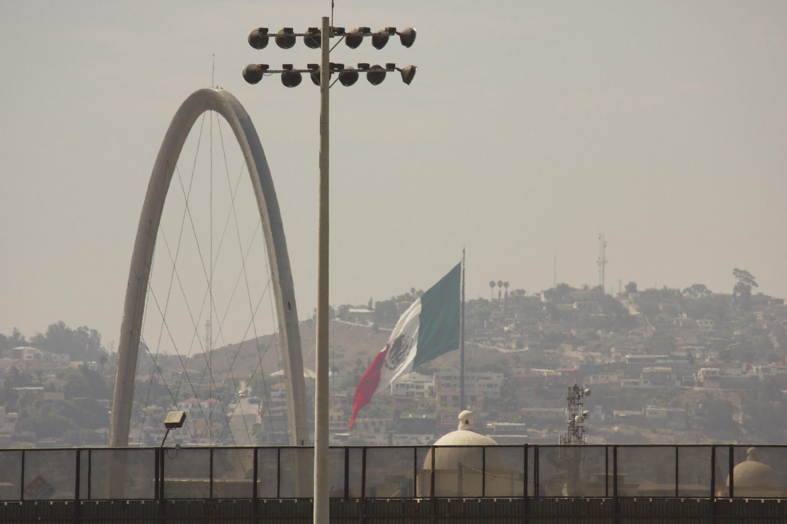 Boundary line between United States and Mexico, from San Diego looking at Tijuana Revolucion Arch