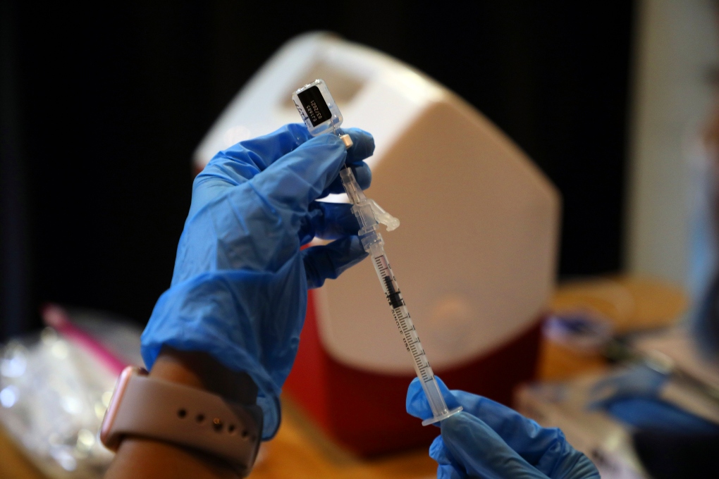 FILE — A syringe is filled with a dose of the Pfizer-BioNTech COVID-19 vaccine at a vaccine center in Rohnert Park, Calif., Jan. 27, 2021. (Jim Wilson/The New York Times)